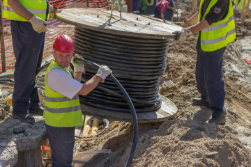 workers moving cable